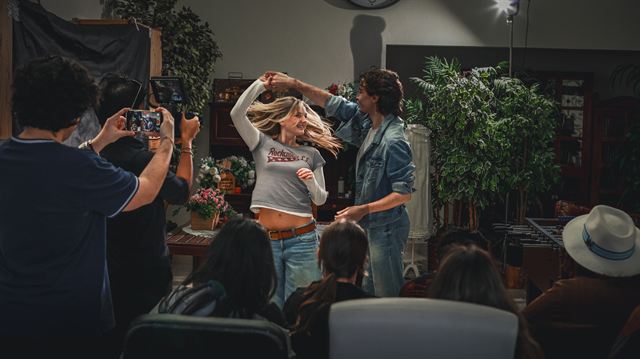 The crew filming a dance scene in a large room