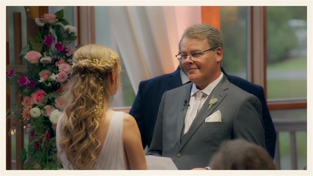 The bride and groom smiling at each other during the ceremony